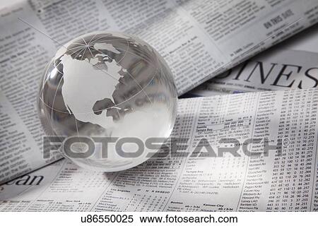 Stock Photography - Studio shot of globe on financial pages. Fotosearch