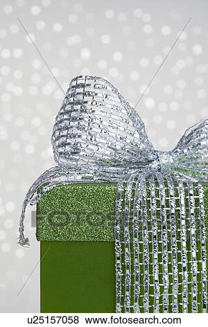 Studio shot of green gift with ribbon on sparkled background, part of View Large Photo Image Stock Photo - Studio shot of green gift with ribbon on sparkled background, part of. Fotosearch