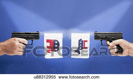 Stock Photography - Studio shot of guns with political parties symbols. Fotosearch