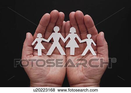 Stock Photo - Studio shot of hands holding papercut family. Fotosearch
