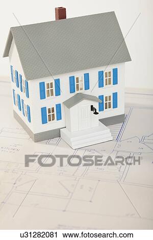 Stock Image - Studio shot of house model and plan. Fotosearch