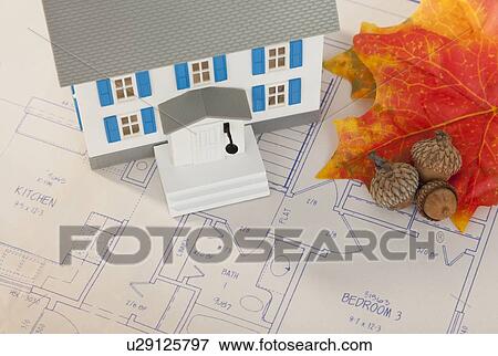 Stock Photo - Studio shot of house model and plan. Fotosearch