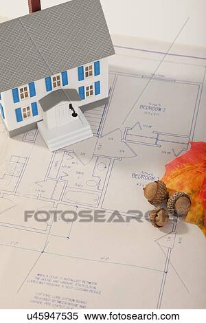Stock Photography - Studio shot of house model and plan. Fotosearch