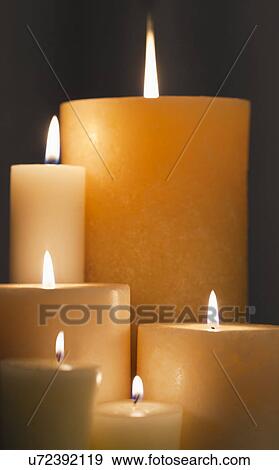 Stock Photo - Studio shot of illuminated candles. Fotosearch