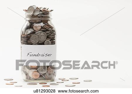 Stock Photo - Studio shot of jar full of coins. Fotosearch