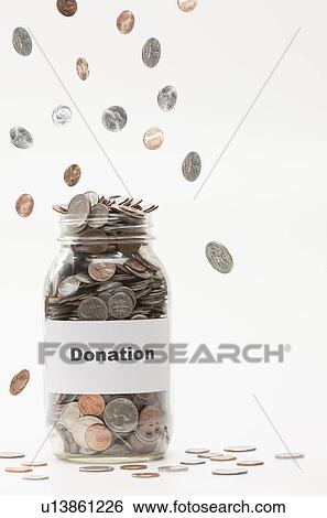 Studio shot of jar full of coins View Large Photo Image Stock Photograph - Studio shot of jar full of coins. Fotosearch