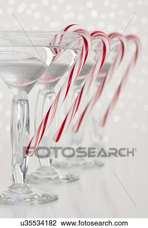 Studio shot of martini drink with peppermint candy cane View Large Photo Image Stock Image - Studio shot of martini drink with peppermint candy cane. Fotosearch