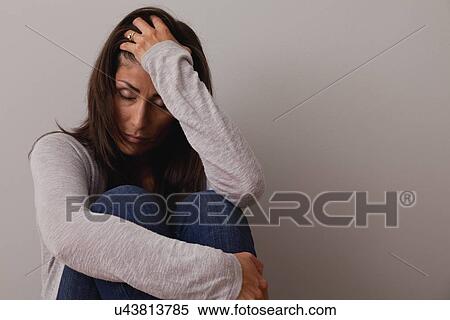 Studio shot of mature woman with head in hand being under stress View Large Photo Image Stock Photography - Studio shot of mature woman with head in hand being under stress. Fotosearch