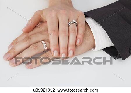 Studio shot of newlywed couple hands View Large Photo Image Stock Image - Studio shot of newlywed couple hands. Fotosearch