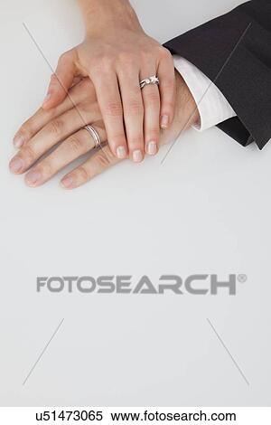 Stock Photography - Studio shot of newlywed couple hands. Fotosearch