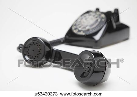 Stock Image - Studio shot of old-fashioned landline phone. Fotosearch