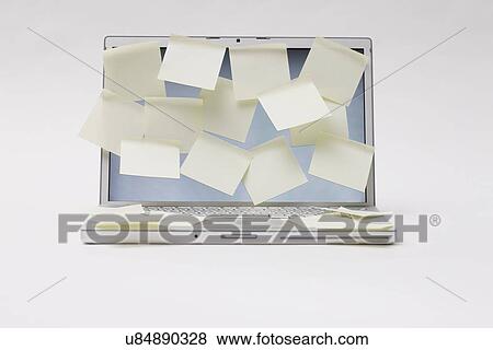 Stock Photo - Studio shot of open laptop with sticky notes on screen. Fotosearch