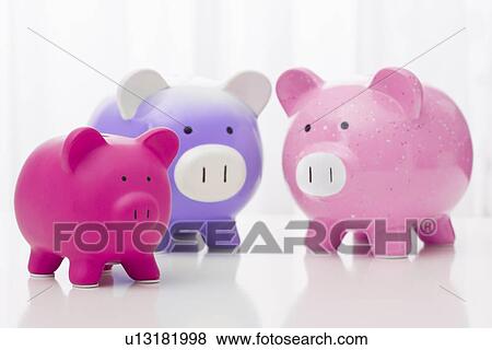 Stock Photo - Studio shot of piggy-banks. Fotosearch