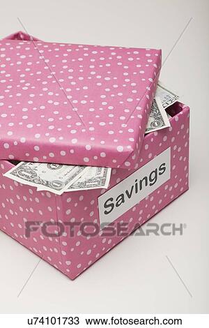 Stock Image - Studio shot of pink box with banknotes. Fotosearch