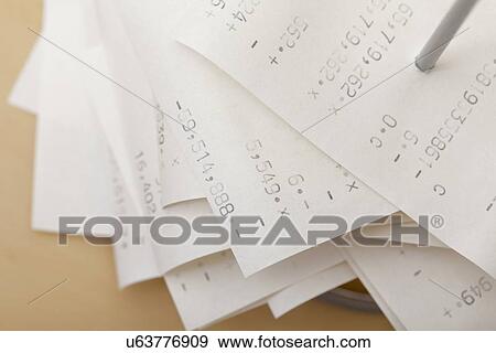 Stock Photo - Studio shot of receipts on spike. Fotosearch