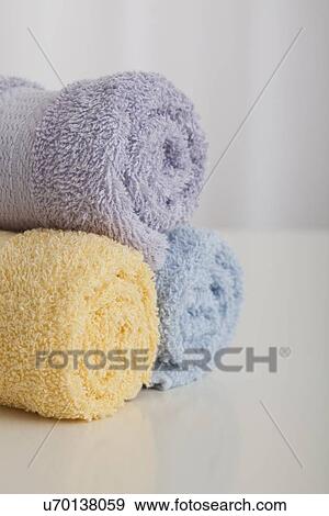 Stock Photo - Studio shot of rolled up of pastel colored towels. Fotosearch