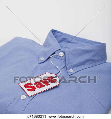 Studio shot of sale tag on folded shirt View Large Photo Image Stock Image - Studio shot of sale tag on folded shirt. Fotosearch