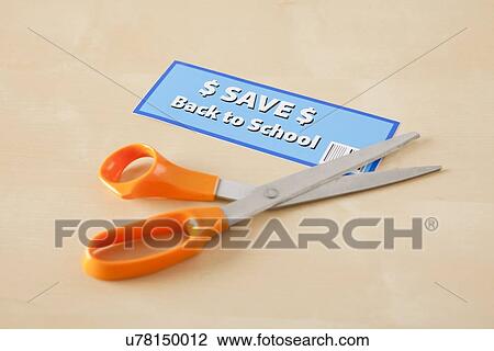 Stock Image - Studio shot of scissors and coupon. Fotosearch