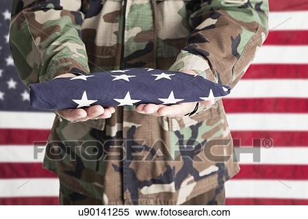 Studio shot of soldier standing against American, mid section View Large Photo Image Stock Photography - Studio shot of soldier standing against American, mid section. Fotosearch