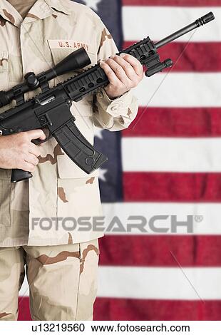 Studio shot of soldier with machine gun standing against American, mid section View Large Photo Image Stock Image - Studio shot of soldier with machine gun standing against American, mid section. Fotosearch