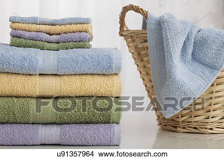 Studio shot of stack of pastel colored towels with Wicker Basket View Large Photo Image Picture - Studio shot of stack of pastel colored towels with Wicker Basket. Fotosearch