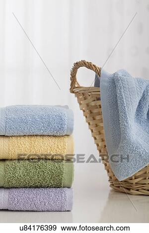 Studio shot of stack of pastel colored towels with Wicker Basket View Large Photo Image Stock Photo - Studio shot of stack of pastel colored towels with Wicker Basket. Fotosearch