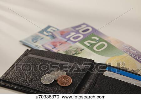 Stock Image - Studio shot of wallet with money. Fotosearch