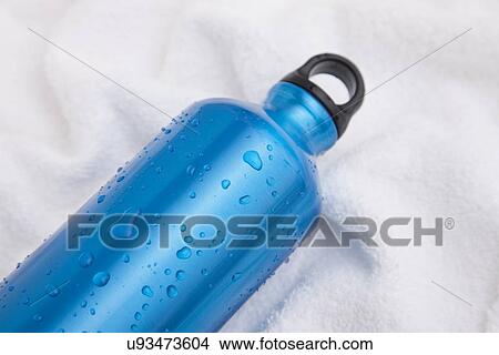 Picture - Studio shot of water bottle on white towel. Fotosearch
