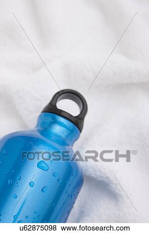 Studio shot of water bottle on white towel View Large Photo Image Stock Photo - Studio shot of water bottle on white towel. Fotosearch