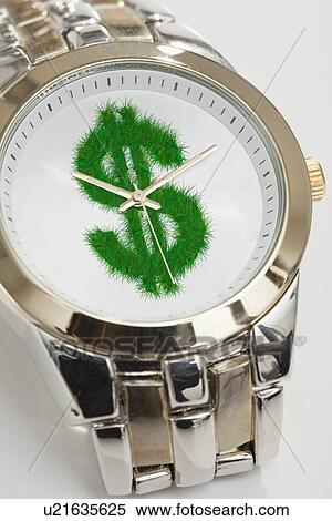 Stock Photography - Studio shot of wristwatch with grassy dollar sign. Fotosearch