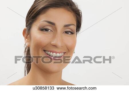 Studio shot portrait of mature woman wearing braces View Large Photo Image Stock Image - Studio shot portrait of mature woman wearing braces. Fotosearch