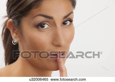 Studio shot portrait of mature woman with finger on lips View Large Photo Image Stock Photography - Studio shot portrait of mature woman with finger on lips. Fotosearch
