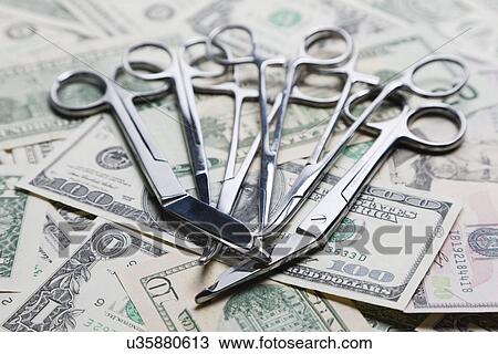 Surgical scissors and clamps on US banknotes, studio shot View Large Photo Image Stock Image - Surgical scissors and clamps on US banknotes, studio shot. Fotosearch