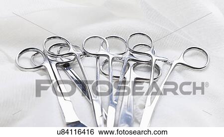 Stock Photograph - Surgical scissors and clamps on white background, studio shot. Fotosearch