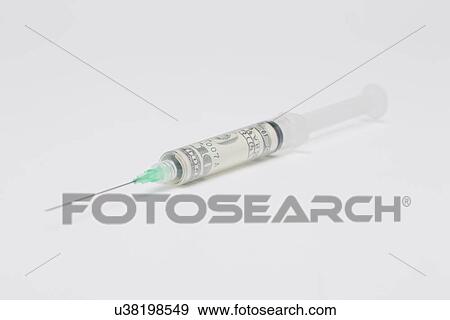 Stock Photo - Syringe with UN note inside, studio shot. Fotosearch
