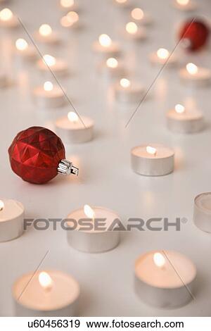 Stock Photo - Tealight candles and Christmas baubles. Fotosearch