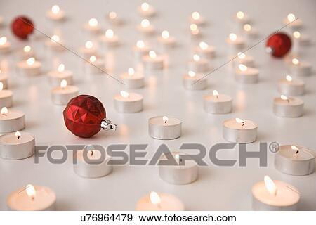 Stock Photo - Tealight candles and Christmas baubles. Fotosearch