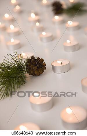 Tealight candles and cones View Large Photo Image Stock Image - Tealight candles and cones. Fotosearch