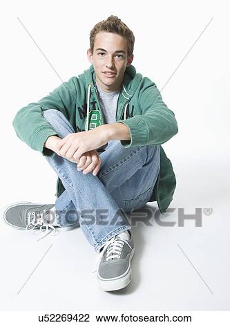 Teenage boy sitting cross-legged, portrait View Large Photo Image Stock Image - Teenage boy sitting cross-legged, portrait. Fotosearch