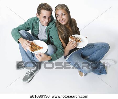 Stock Photograph - Teenage couple eating pizza. Fotosearch