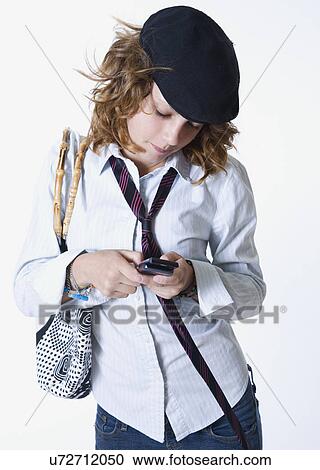 Stock Image - Teenage girl (14-15) text messaging. Fotosearch