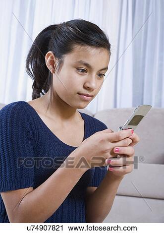 Teenage girl (14-15) text messaging View Large Photo Image Stock Image - Teenage girl (14-15) text messaging. Fotosearch