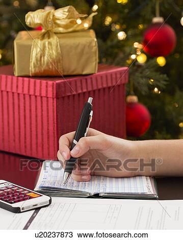 Teenage girl (14-15) with cheque book buying gifts for Christmas View Large Photo Image Stock Image - Teenage girl (14-15) with cheque book buying gifts for Christmas. Fotosearch