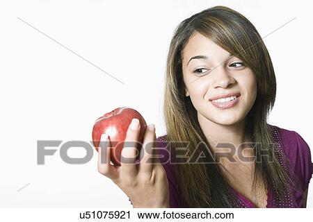 Teenage girl holding apple View Large Photo Image Stock Image - Teenage girl holding apple. Fotosearch