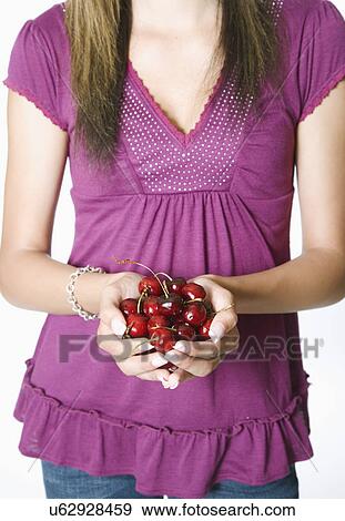 Teenage girl holding cherries View Large Photo Image Stock Photo - Teenage girl holding cherries. Fotosearch