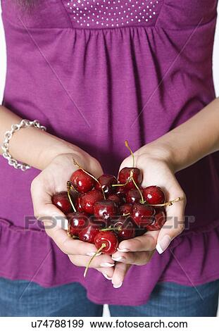 Teenage girl holding cherries View Large Photo Image Stock Photo - Teenage girl holding cherries. Fotosearch