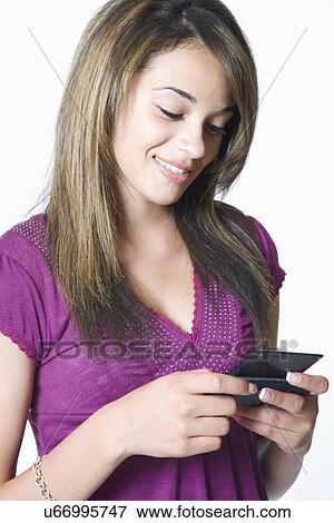 Teenage girl using mobile technology View Large Photo Image Stock Photo - Teenage girl using mobile technology. Fotosearch