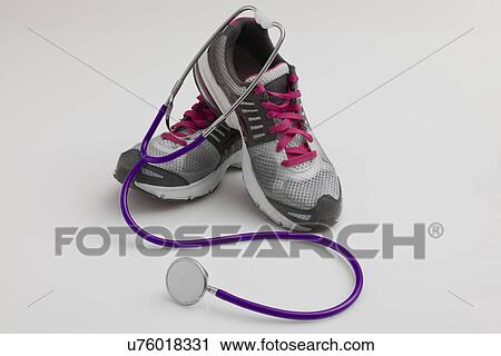 Stock Image - Tennis shoes and stethoscope. Fotosearch