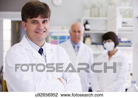 Stock Image - Three scientist in laboratory, portrait. Fotosearch