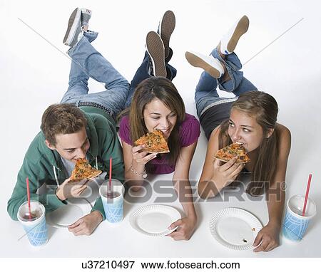 Stock Photo - Three teenage friends eating pizza. Fotosearch
